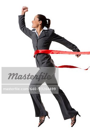 Businesswoman crossing finish line