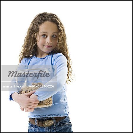 Young girl holding cookie jar