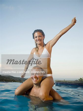 Close-up of a man carrying a woman on his shoulders