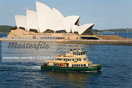 A Sydney ferry cruises past the Opera House toward the wharf at Circular Quay