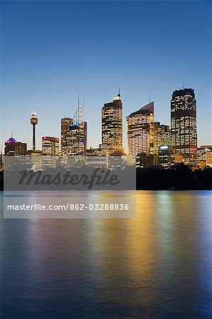 The lights of the central Sydney skyline are reflected in the waters of Farm Cove on Sydney harbour