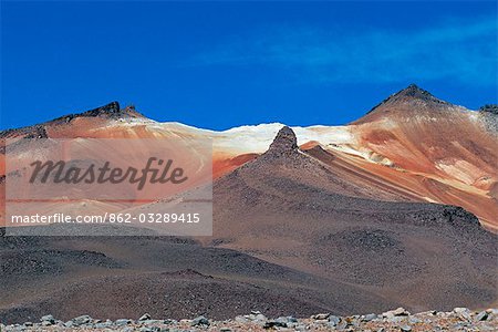 Cerro Rosario,one of the volcanic Andean peaks rising above the altiplano,gets its name from the red streaks of minerals on its upper slopes.