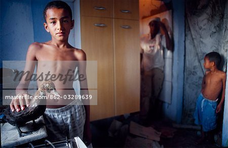 A young boy with his pet duck at his home in a Sao Paulo Favela