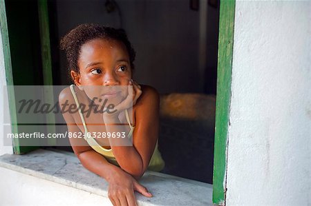 Brazilian girl of African decent gazes out of the window in a village on the Tinhare archipelago in the Bahia region,north east of Brazil
