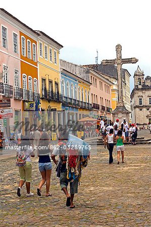 Brazil,Bahia,Salvador. Within the historic Old City,a UNESCO World Heritage site,groups of tourists are approached by a street vendor in front of the Sao Francisco Church and Convent of Salvador.