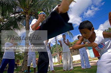 Brésil, Bahia, île de Boipeba. Garçons et les jeunes hommes s'entraînent au Capoeira la danse martiale de danse ritualiste esclave du Brésil où mouvements par étapes masquer les positions de combats, postures défensifs et offensifs jabs.