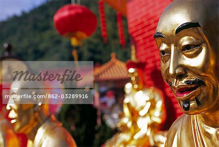 Lifelike features of one of the many golden Buddhas at the Ten Thousand Buddhas Monastery near Sha Tin in the New Territories Hong Kong.