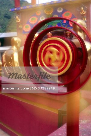 A Buddhist wheel of life is spun at the Ten Thousand Buddhas Monastery near Sha Tin in the New Territories,Hong Kong