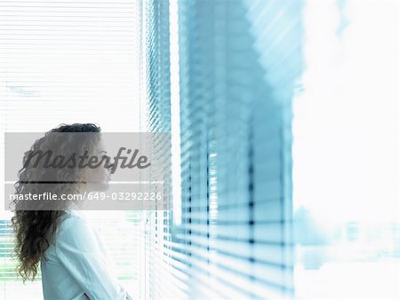 Business woman looking through window