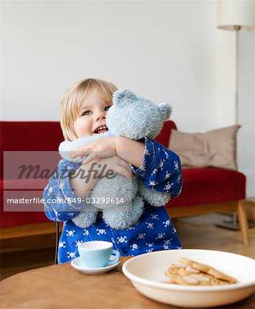 A boy toddler cuddling his teddy bear