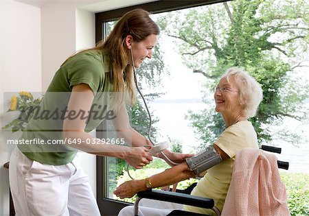 nurse taking woman's blood pressure