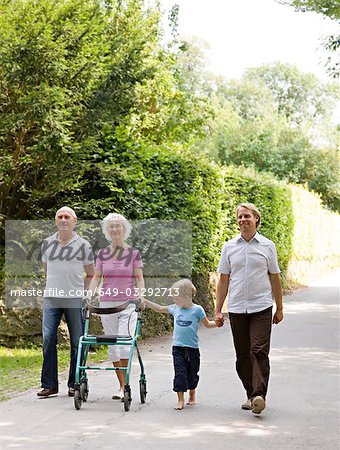 senior couple, father and son walking