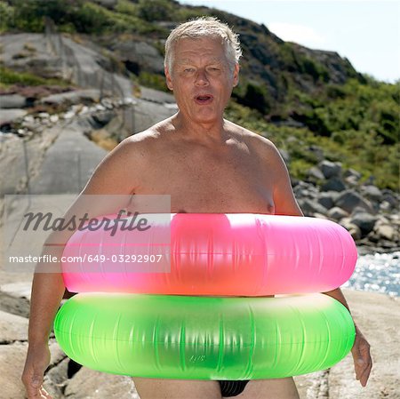 Senior man with two inflatable rings