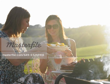 young women having barbecue
