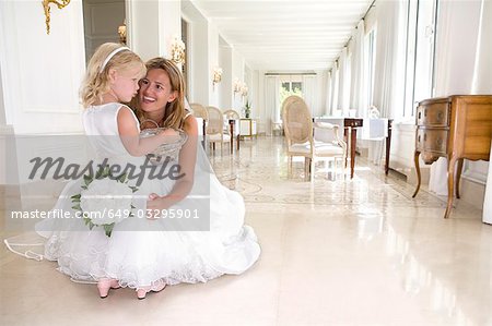 bride with young flower girl talk