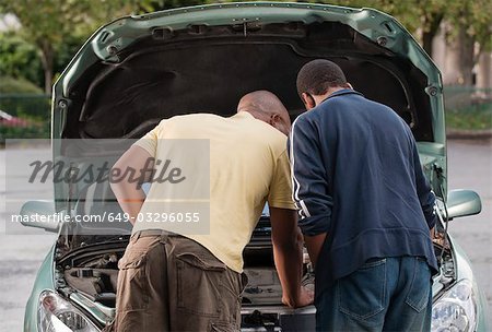 father & son working on car