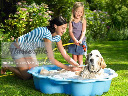 Mutter und Tochter den Hund waschen