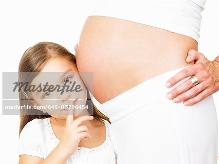 Girl next to her mother's pregnant belly