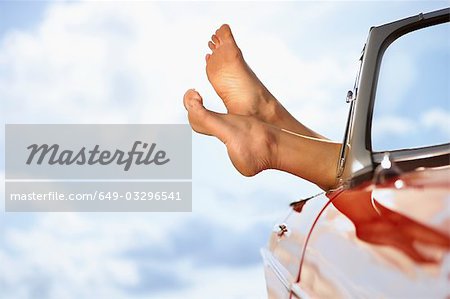 Woman's feet sticking out of car window