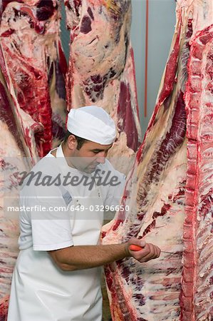 Butcher working on half a cow.