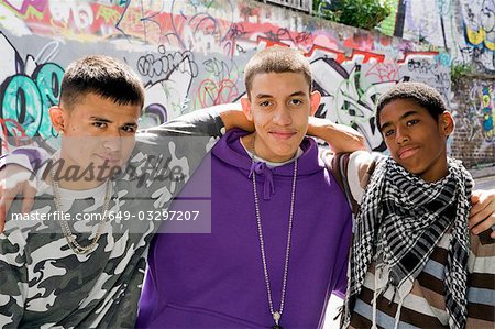 Teenage gang against graffiti wall