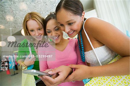 Trois filles regarder photo de téléphone cellulaire