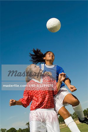 Girls (13-17) attempting to head soccer ball
