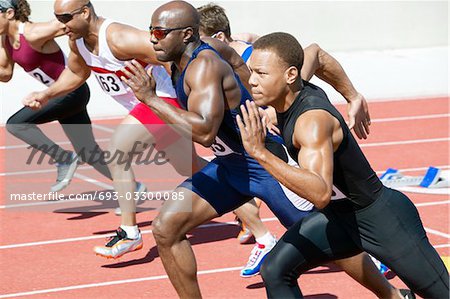 Male athletics sprinting on running track