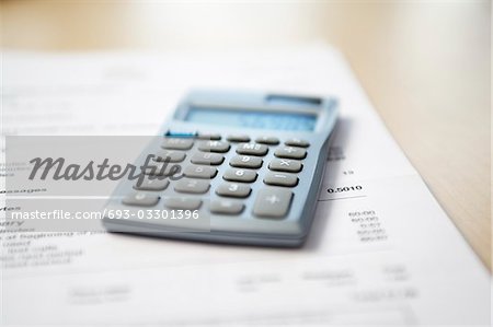 Calculator lying on telephone bill, close-up