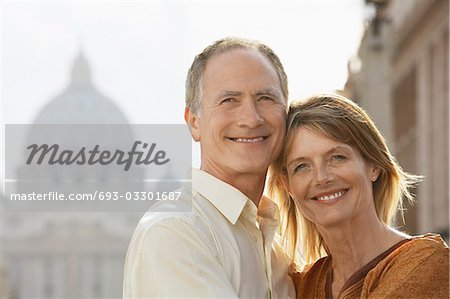 Middle-aged couple hugging in Rome, Italy, front view, portrait