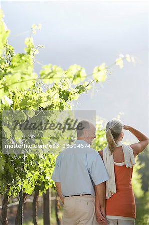 Mature couple at the vineyard, back view