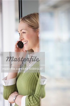 Business woman using mobile phone in office