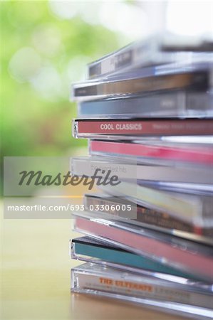 Pile of CD jewel cases on table, close-up