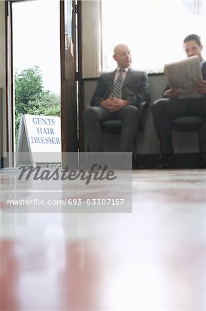Two business men waiting in barber shop