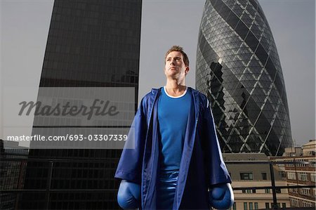 Boxer standing on downtown rooftop, London, England