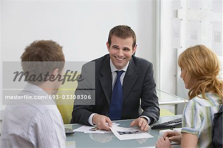 Couple avec agent immobilier dans le Bureau