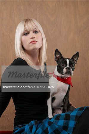 Junge Frau mit französische Bulldogge auf Schoß