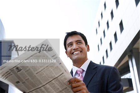 Business man holding take-out coffee cup on city street