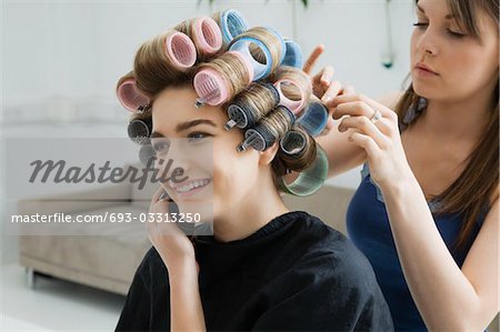 Hairstylist Rolling Hair of Model