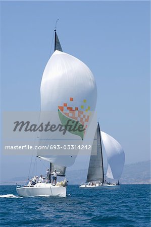 Two yachts compete in team sailing event, California