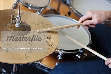 Caucasian man plays drum set