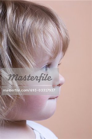 Side view, profile of blonde toddler with baby curls