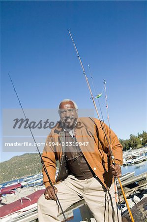 Middle-aged fisherman standing at marina, (portrait)