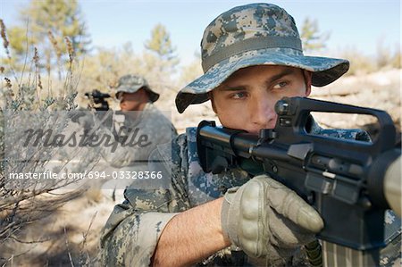 Two soldiers with weapons, close-up