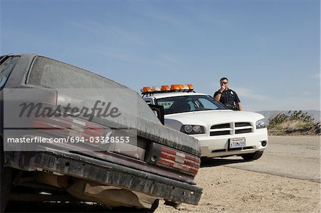 Police officer talking on CB radio on roadside