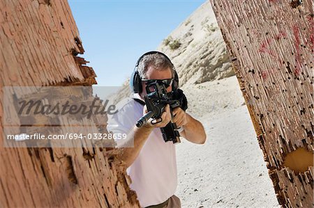 Man aiming machine gun at firing range