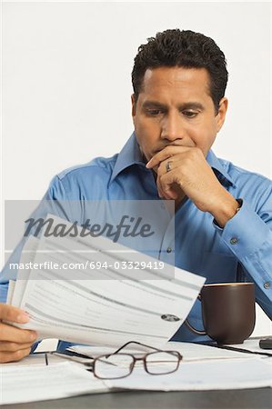 Man Reading a Tax Form
