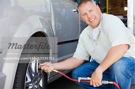 Man Filling Tires on RV