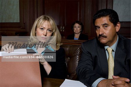 Man and woman sitting in court, portrait