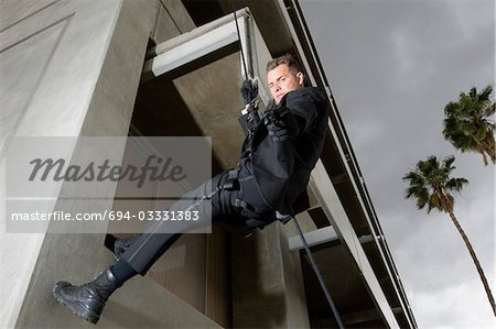 SWAT Team Officer Rappelling from Building